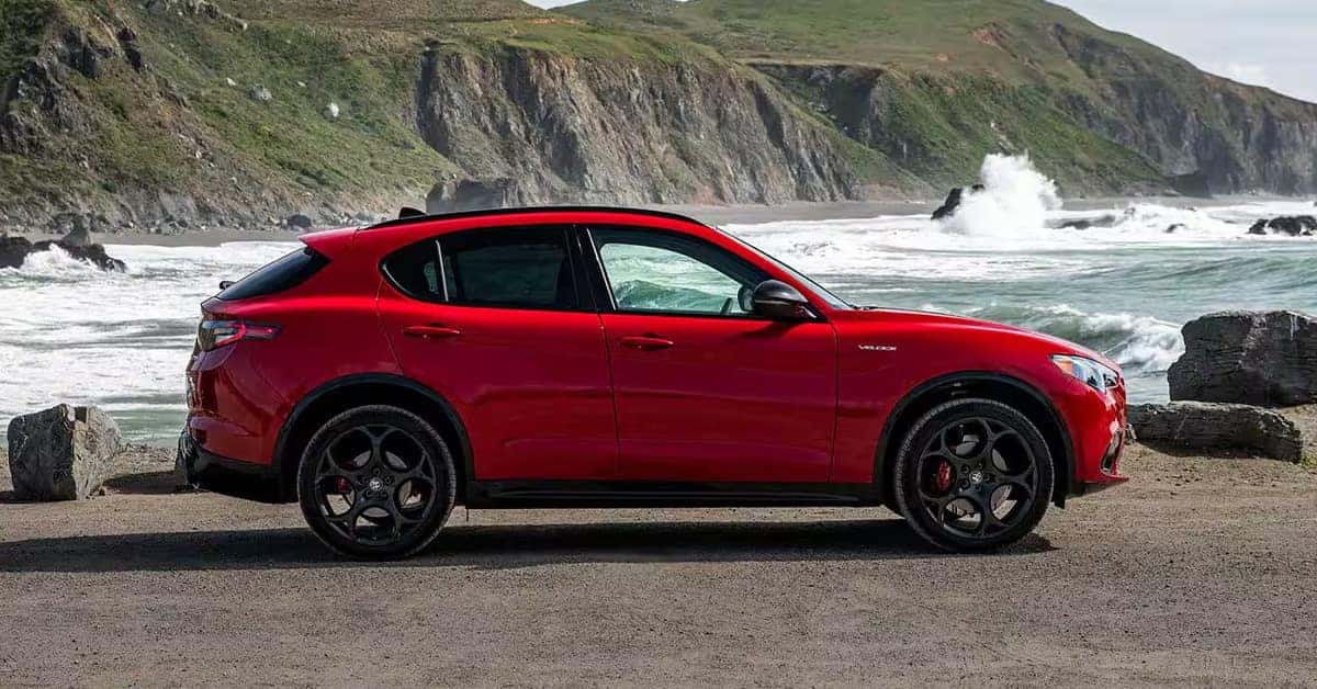 A red 2026 Alfa Romeo Stelvio parked near the waters