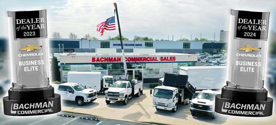 Trucks in front of Commercial Sales building with awards on side