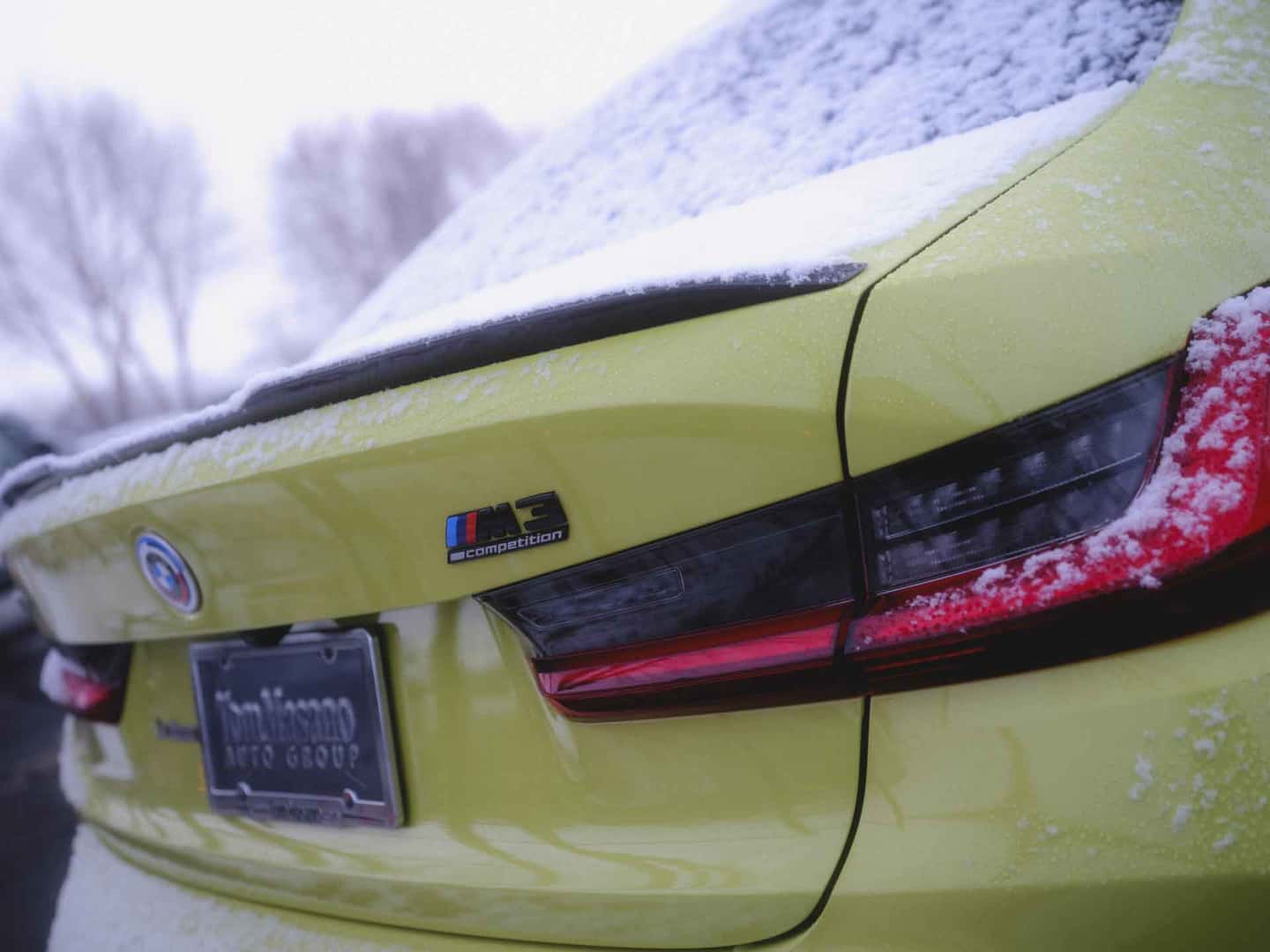 yellow BMW sports car with a blanket of snow