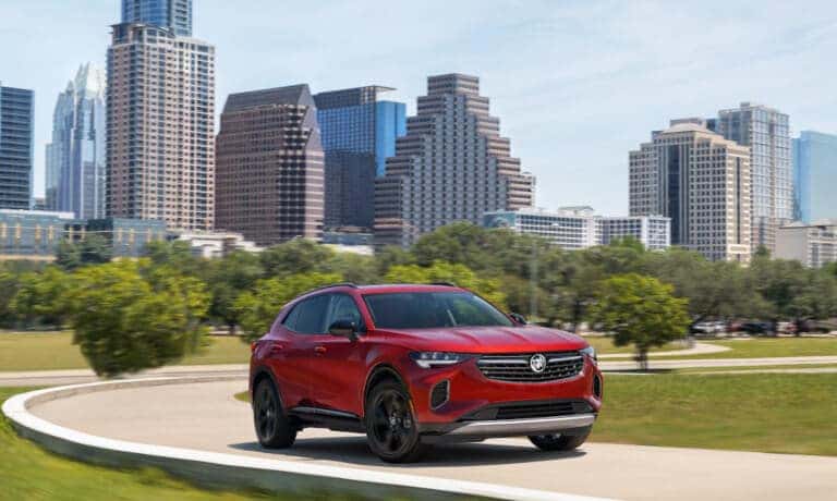 2023 Buick Envision Exterior Driving In Front Of City Skyline