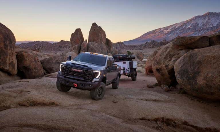 2024 GMC Sierra 2500 Exterior On Rocks With A Camper