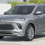 A gray 2024 Buick Encore GX is shown parked near a Buick dealer near Lombard .