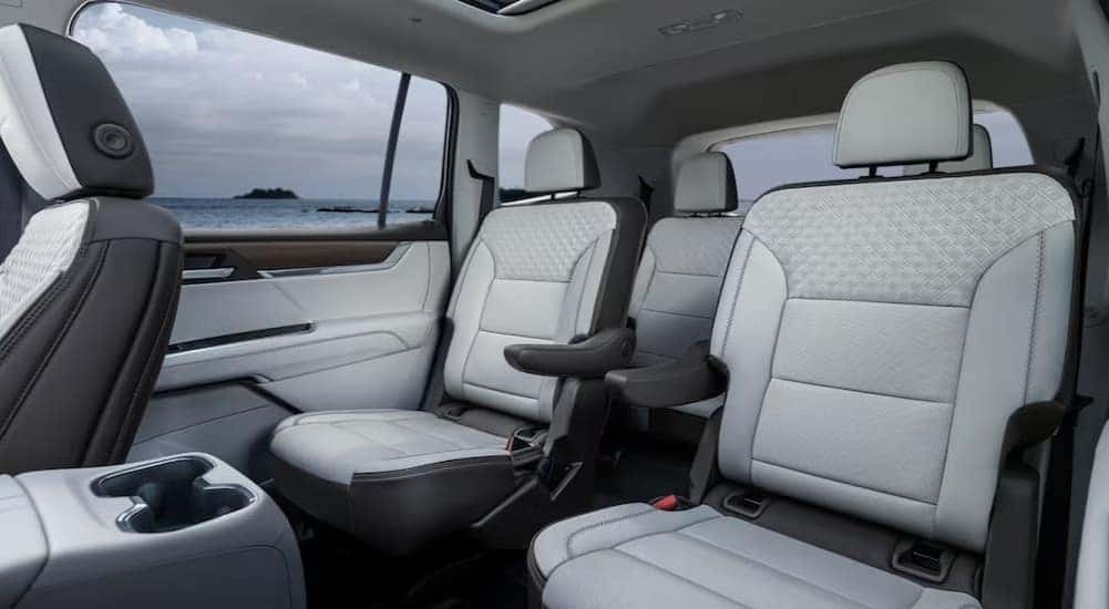 The white and black interior of a 2024 GMC Acadia AT4 is shown.