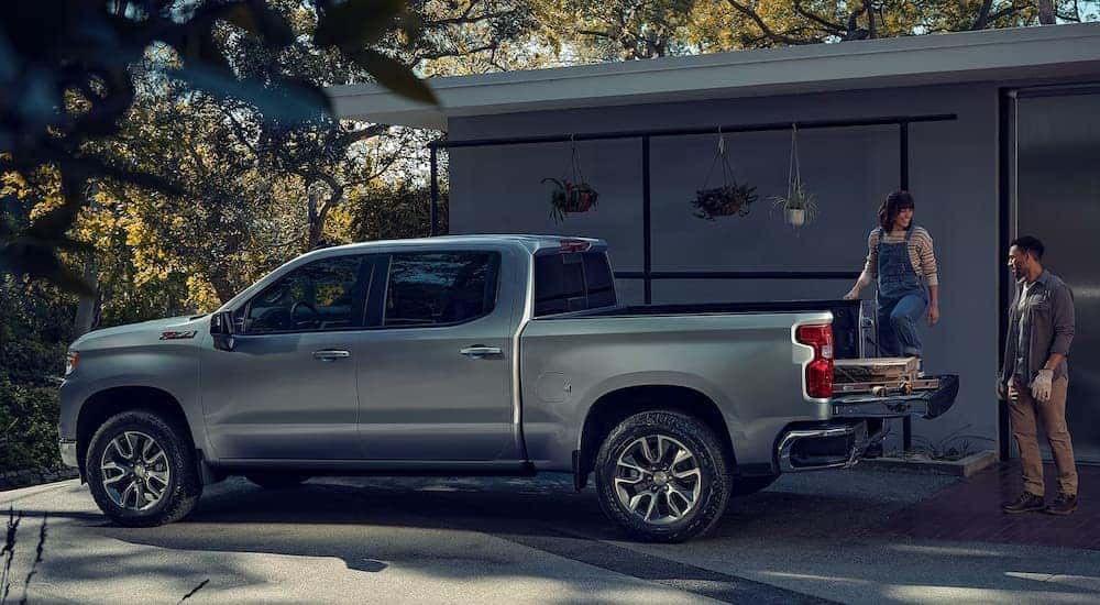 A silver 2024 Chevy Silverado LT Z71 parked in a driveway.