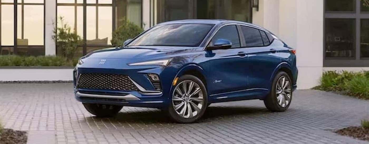 A blue 2024 Buick Envista is shown parked near a house.