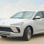 A white 2024 Buick Envista Avenir with mountains in the distance.