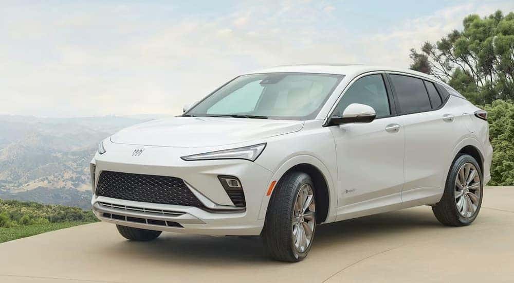 A white 2024 Buick Envista Avenir with mountains in the distance.