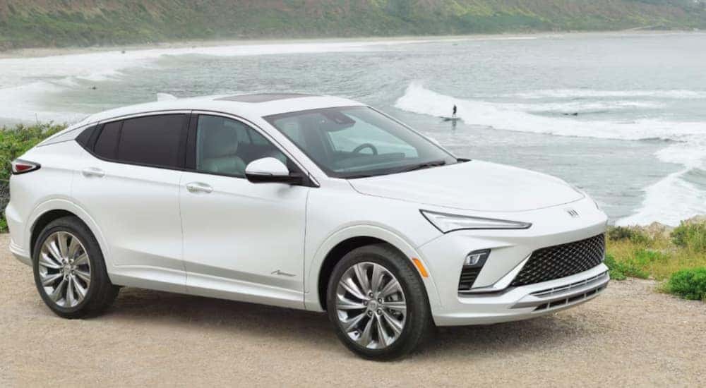A white 2024 Buick Envista Avenir parked overlooking the ocean.