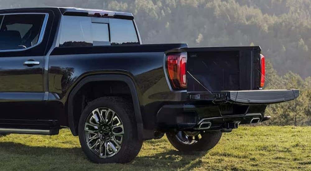 A close-up of the rear end of a black 2024 GMC Sierra 1500 Denali is shown.