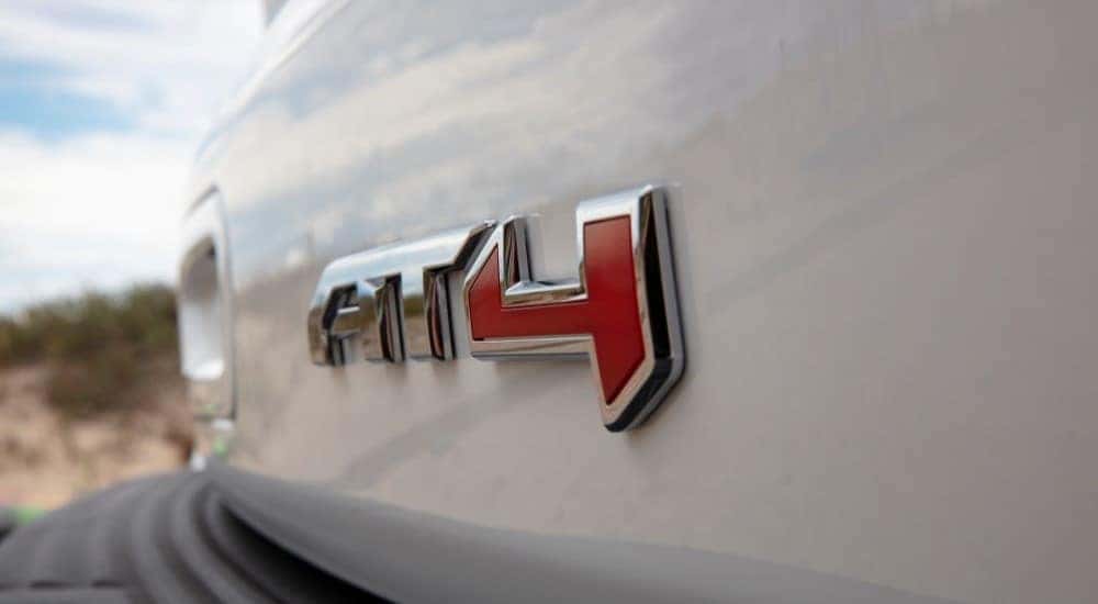 A close ups shows the 'AT4' badge on a GMC Yukon.