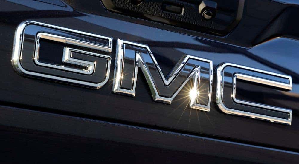 A close up shows a GMC badge.