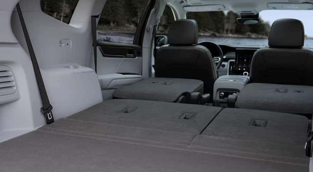 The rear white and gray interior in a 2024 GMC Acadia Denali is shown.