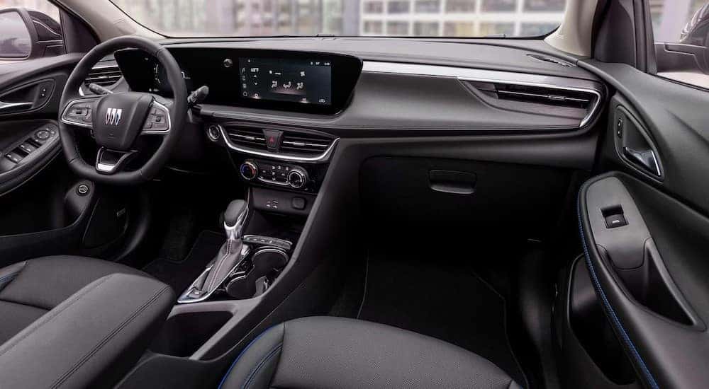 The black and white interior and dash are shown in a 2025 Buick Encore GX.
