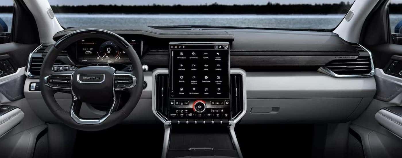 The black and gray interior and dash are shown in a 2024 GMC Acadia Denali.