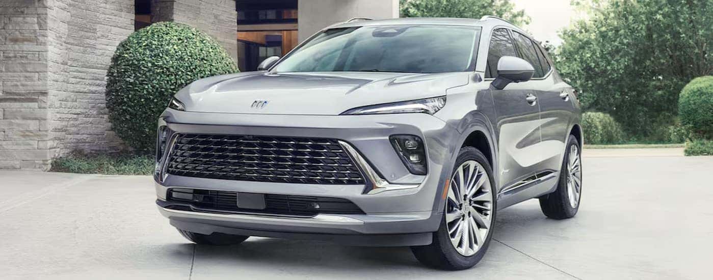 A silver 2024 Buick Envision Avenir is shown parked on a driveway.