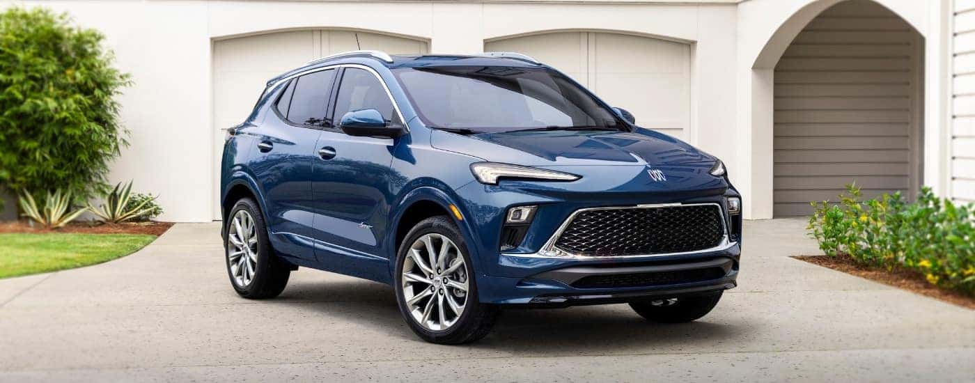 A blue 2024 Buick Encore GX is shown parked on a driveway after visiting a Buick dealer near Bloomingdale.