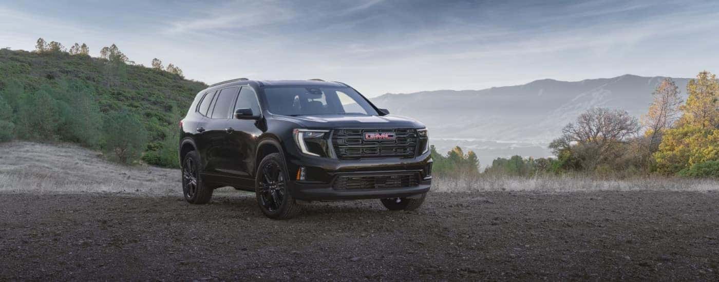 A black 2025 GMC Acadia for sale near Naperville at an overlook.