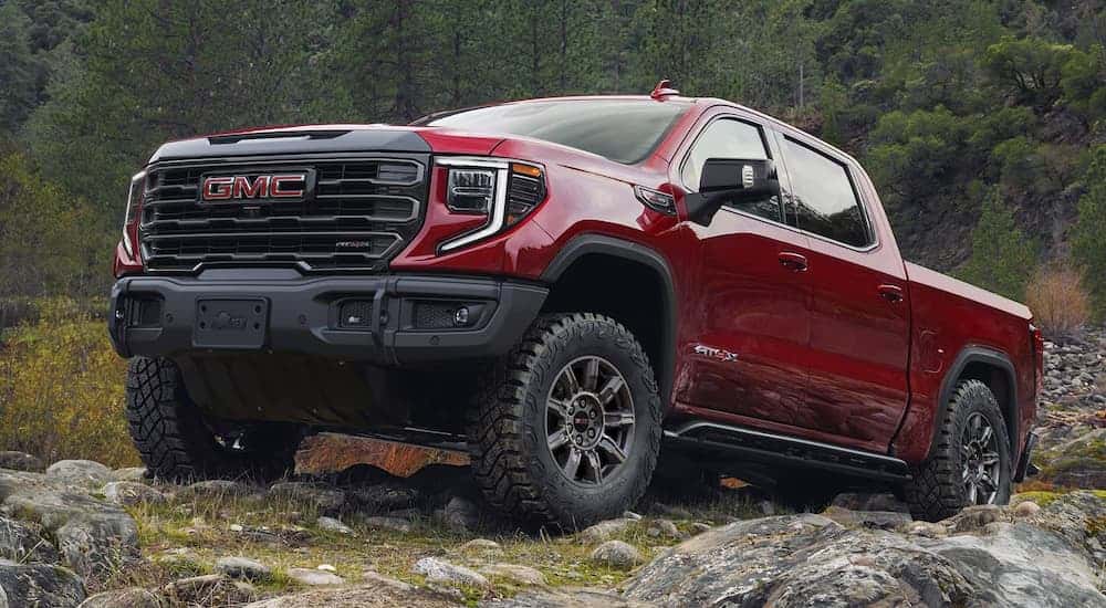 Red 2025 GMC Sierra 1500 parked off-road.