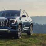 Blue 2026 GMC Terrain Denali for sale near Naperville parked on grass.