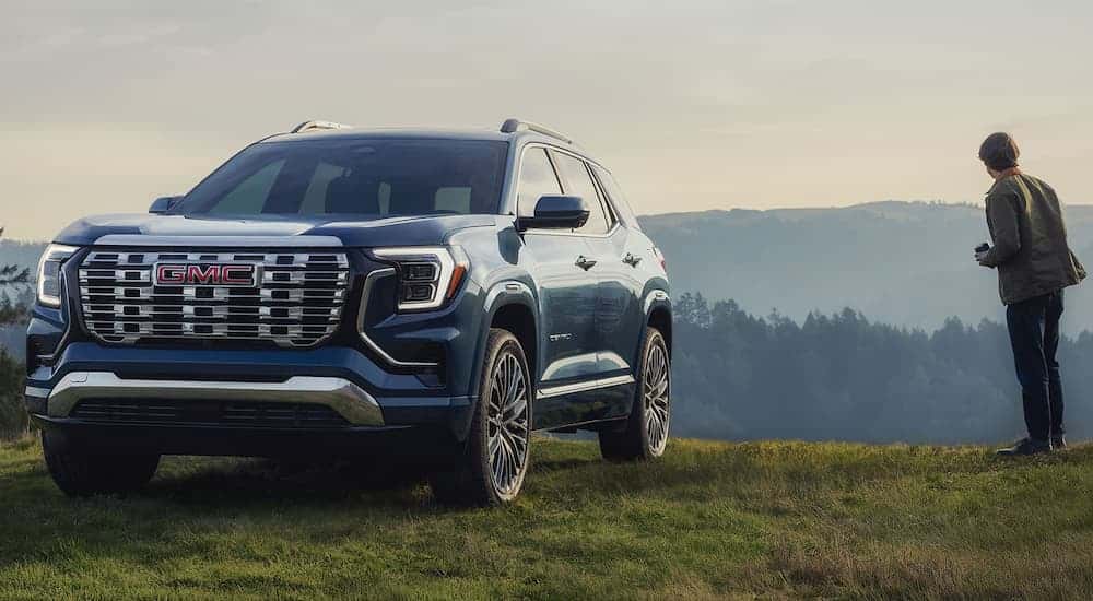 Blue 2026 GMC Terrain Denali for sale near Naperville parked on grass.