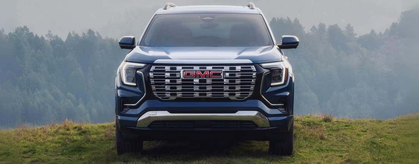 A blue GMC Terrain for sale near Naperville parked off-road.