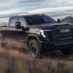 Black 2026 GMC Sierra 2500 HD AT4X for sale driving off-road.