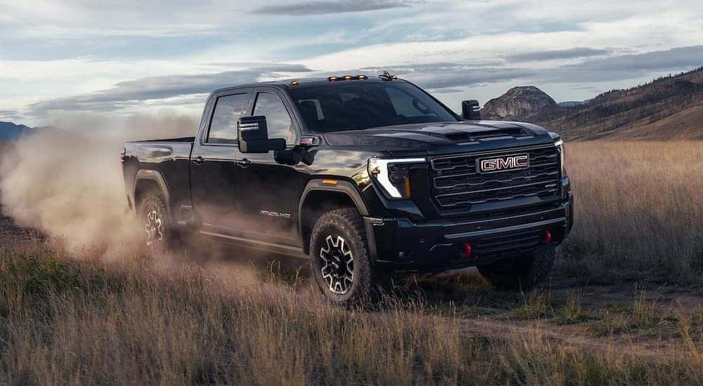 Black 2026 GMC Sierra 2500 HD AT4X for sale driving off-road.