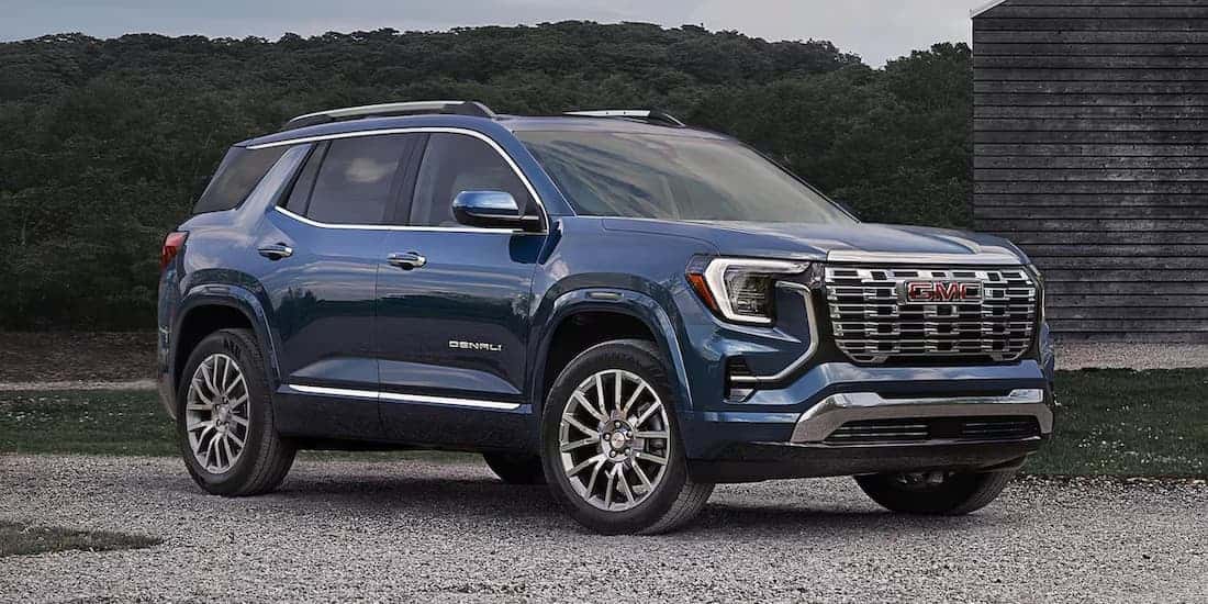 A blue 2026 GMC Terrain parked off-road.