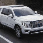 White 2026 GMC Yukon driving down the road