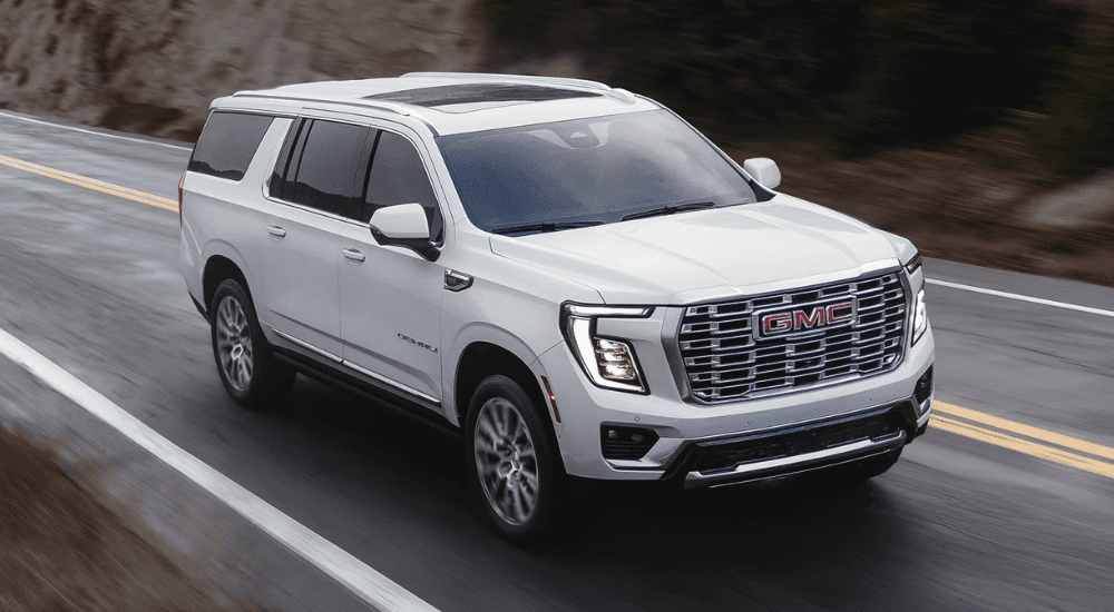 White 2026 GMC Yukon driving down the road