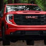Red 2026 GMC Sierra 1500 for sale near Geneva driving off-road.