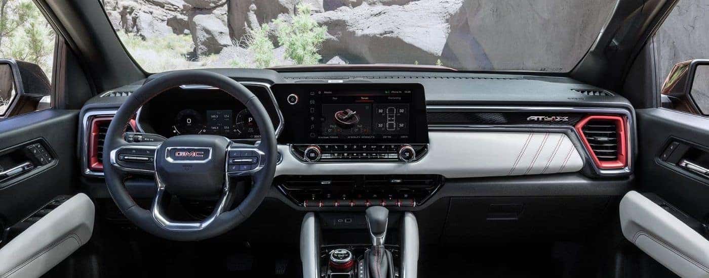 A 2026 GMC Canyon front view of infotainment, steering wheel and digital gauge cluster.