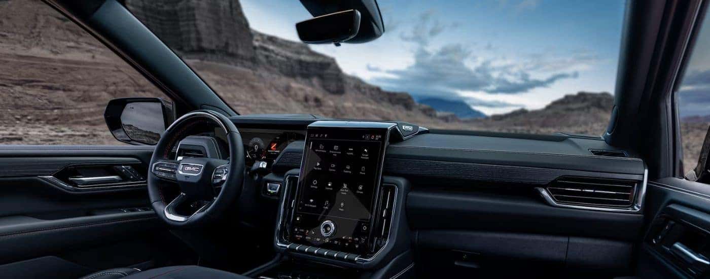 Interior view of a 2026 GMC Yukon infotainment and steering wheel.