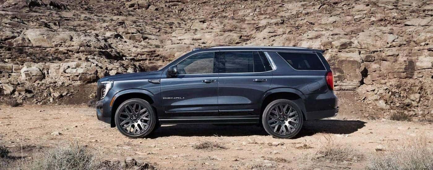 Side view of a grey 2026 GMC Yukon parked off-road