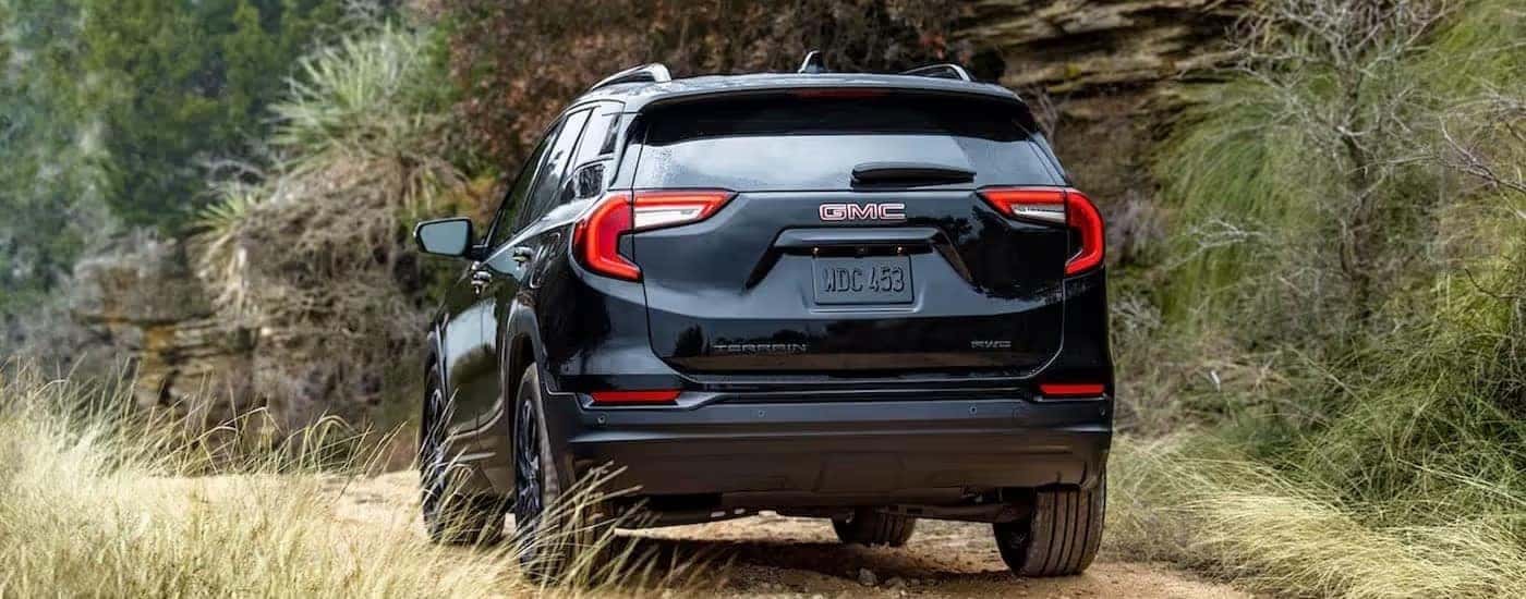 Black 2024 GMC Terrain driving down a trail