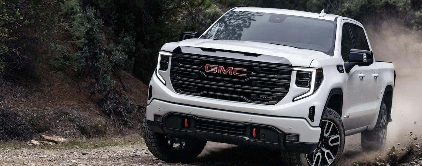 A white 2025 GMC Sierra 1500 AT4 off-roading
