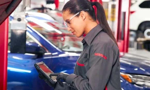 Nissan technician servicing a vehicle