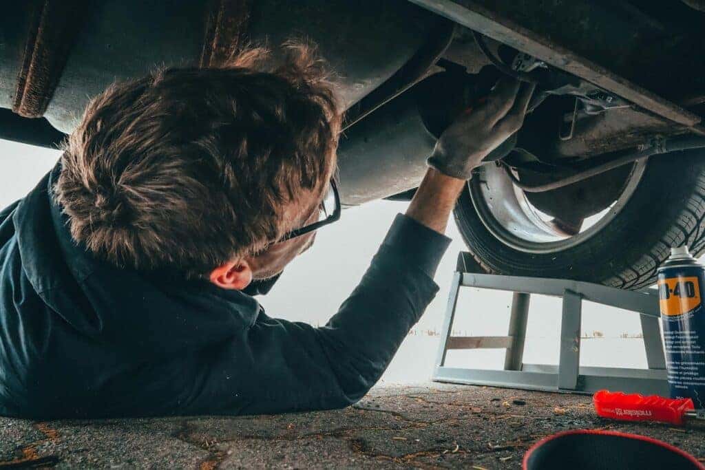 Man Fixing Vehicle