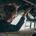 Man Fixing Vehicle