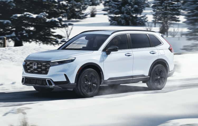 2025 Honda CR-V in white driving on a snowy road