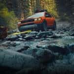 Honda Passport driving over rocky terrain