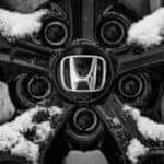 Close Up Shot of a Honda Wheel with Snow