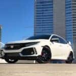white Honda car parked near building