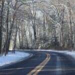 A road in the middle of a snowy forest