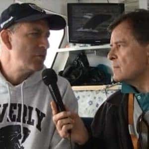 man speaking into microphone to interviewer