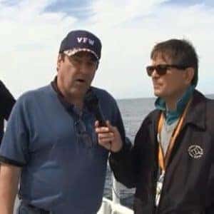 veteran with hat getting interviewed