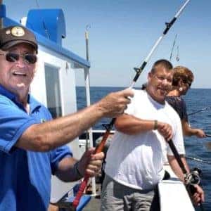 veterans fishing off side of boat