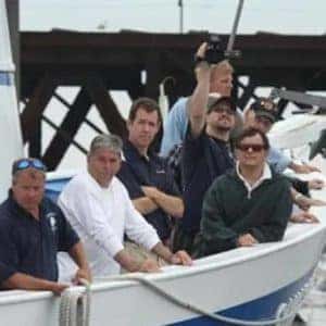 veterans leaning on side of ships rail at the bow