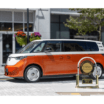 Orange VW. Buzz | J.D. Power Award in front