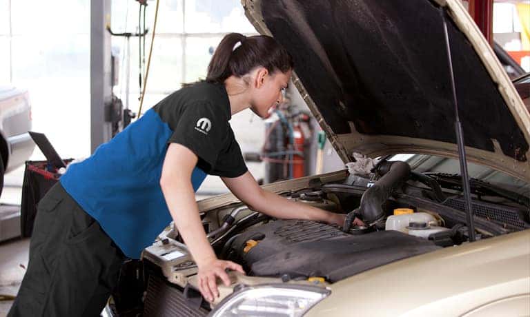 Service Tech Checking The Engine